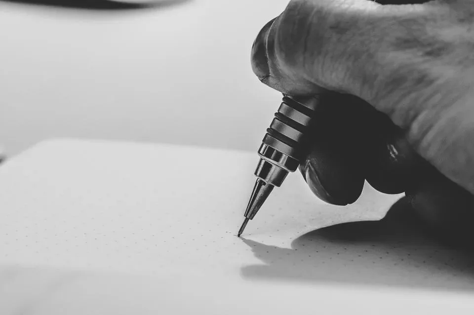 Drawing a design in pencil.